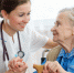 Senior woman is visited by her doctor or caregiver - Лужская МБ